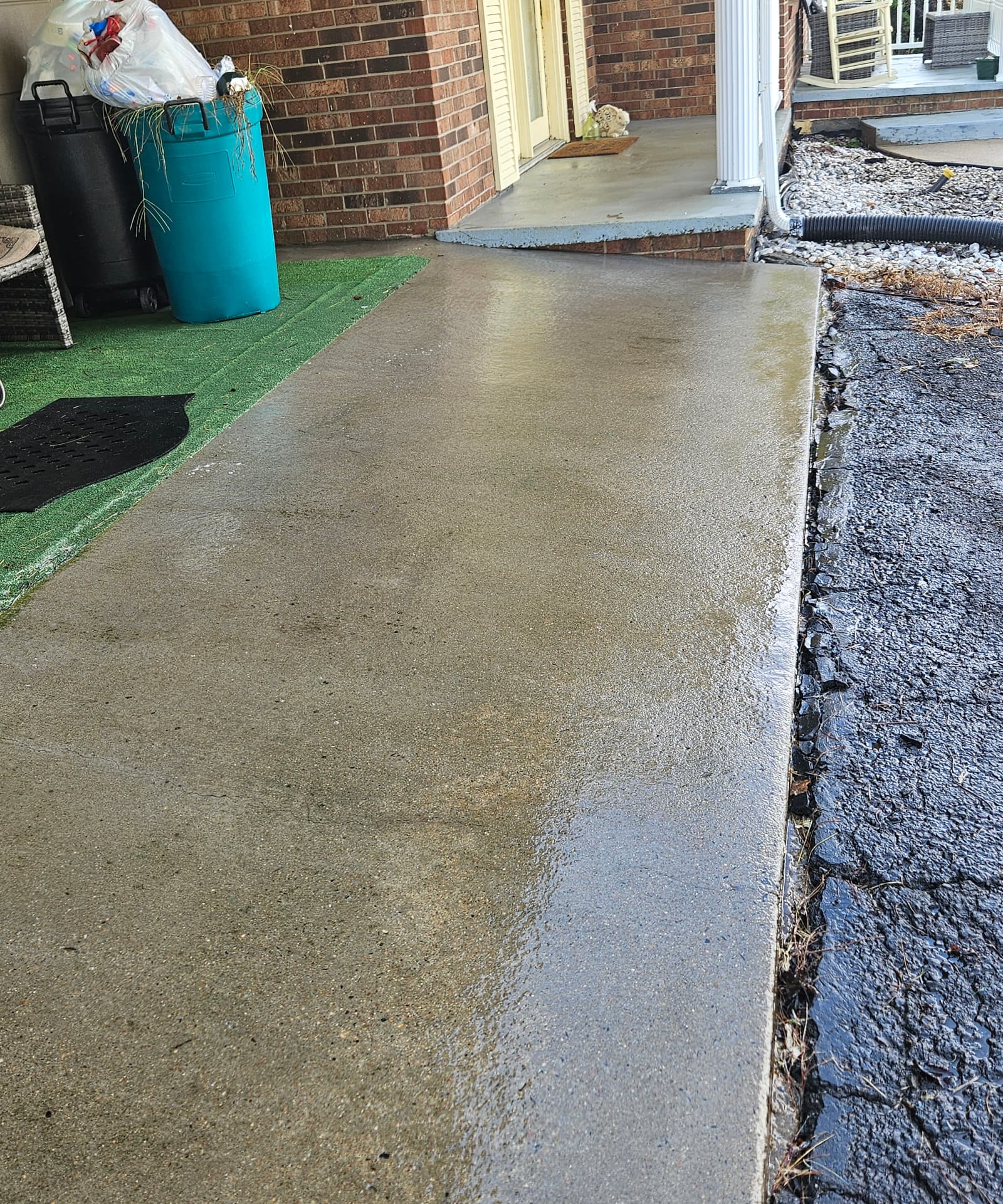 Concrete walkway during surface cleaning by Rodro's Pressure Wash LLC