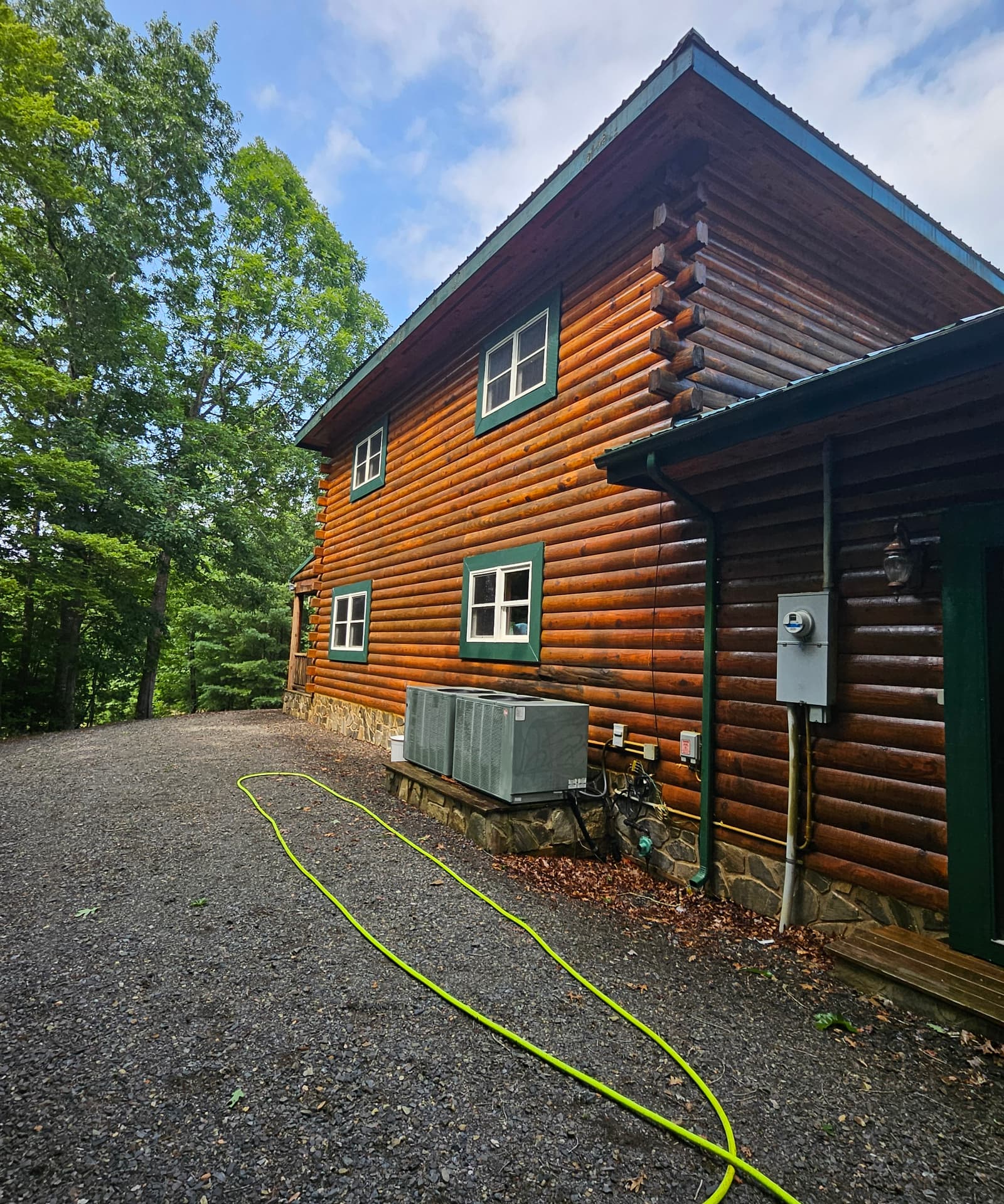 Log cabin exterior being pressure washed by Rodro's Pressure Wash LLC